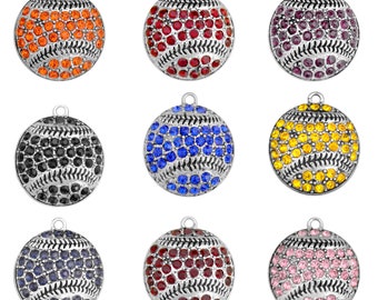 May include: Nine silver baseball charms with different colored rhinestones. The charms are round and have a baseball stitch design. The colors of the rhinestones are orange, red, purple, black, blue, yellow, navy blue, maroon, and pink.