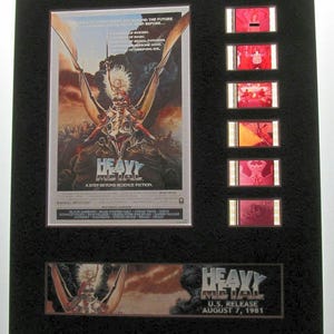 May include: A framed movie poster for the 1981 animated film "Heavy Metal". The poster features a woman riding a winged creature. The frame includes five film strips from the movie.