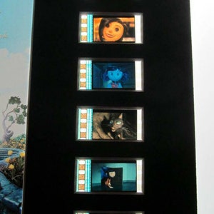May include: A black frame with a series of film strips showing different characters from the movie "Corpse Bride". The film strips are arranged vertically and show a variety of characters, including the bride, the groom, and a cat.