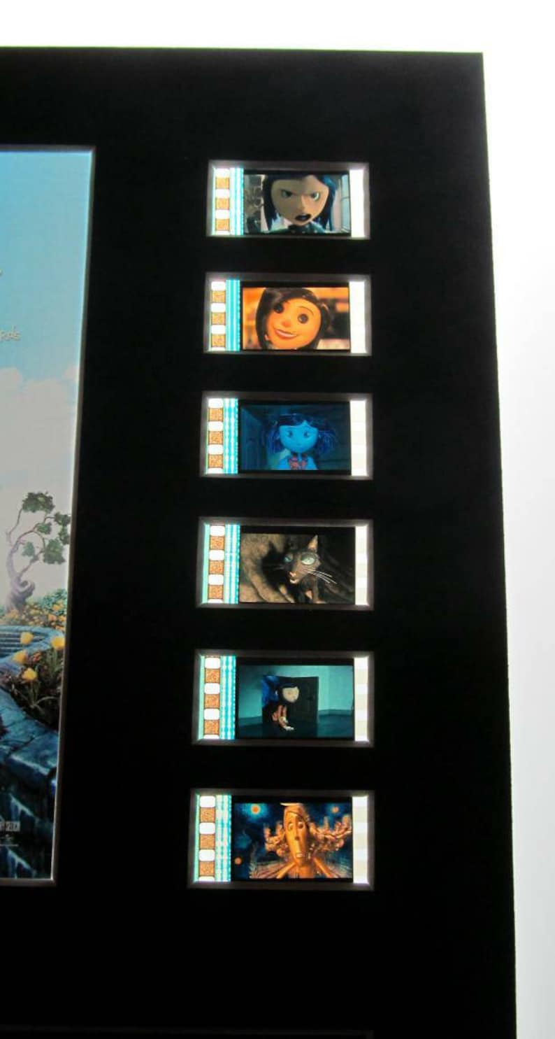 May include: A black frame with a series of film strips showing different characters from the movie "Corpse Bride". The film strips are arranged vertically and show a variety of characters, including the bride, the groom, and a cat.