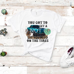 May include: White t-shirt with a blue truck driving through mud with the text "You got to get a little mud on the tires".
