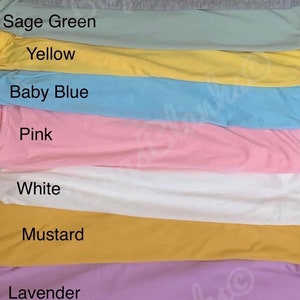 May include: A vertical display of fabric swatches in various colors, including teal, rose, grey, sage green, yellow, baby blue, pink, white, mustard, lavender, cream, and mint. Each swatch is labeled with its corresponding color name.