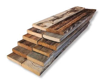 May include: A stack of reclaimed wood planks in various shades of brown, gray, and white. The wood has a rustic, weathered look and is perfect for crafting projects.