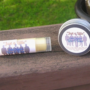 May include: Two small containers of solid cologne, both labeled "Just a Little* Solid Cologne Like a Boss". The containers are white with black text and a graphic of five men in suits.