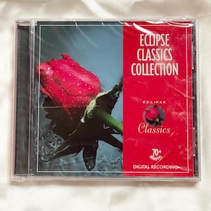 May include: A CD case featuring the "ECLIPSE CLASSICS COLLECTION." The cover art displays a vibrant red rose with water droplets against a dark background. The right side of the case is red with white text.
