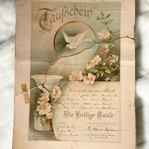 May include: An antique baptismal certificate with German text, featuring a dove, flowers, and a decorative vase. The document is aged, with visible cracks and wear, and has a faded color palette of beige, pink, and green.