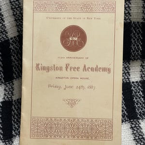 May include: A vintage program from the Kingston Free Academy's 113th anniversary, dated June 24th, 1887. The program features ornate borders and text in a serif font, with the University of the State of New York seal.