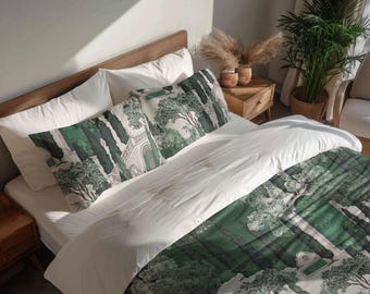 May include: A bed with white bedding and a duvet cover and pillowcases featuring a green and white landscape design. The design includes trees, buildings, and a garden. The bed is made of wood and is in a well-lit room.