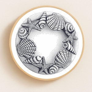 May include: A circular artwork featuring a detailed black and white illustration of various seashells and starfish arranged in a wreath. The design is set against a dotted background, framed by a light wood border, evoking a coastal theme.