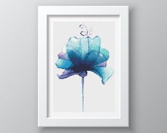 May include: A framed cross-stitch artwork depicting a stylized blue flower with purple hues. The flower is on a long stem, set against a white backdrop. The frame is white.
