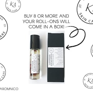 Pode incluir: Um frasco roll-on de vidro transparente de mistura de &oacute;leos essenciais de lavanda e eucalipto com tampa preta, ao lado de uma caixa preta. O texto no frasco e na caixa diz "Lavender Eucalyptus Essential Oil Blend". A imagem tamb&eacute;m inclui o texto "Buy 8 or more and your roll-ons will come in a box!"