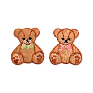 May include: Two embroidered teddy bear patches. Each bear is light brown with black eyes and a small bow tie. One bow tie is light green, and the other is pink. The patches are on a white background.