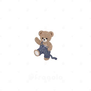 May include: An embroidered design of a light brown teddy bear with dark eyes and a stitched nose. The bear is wearing blue denim-style overalls with visible stitching and a single strap extending to the side, depicted in a waving pose.