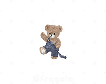 May include: An embroidered design of a light brown teddy bear with dark eyes and a stitched nose. The bear is wearing blue denim-style overalls with visible stitching and a single strap extending to the side, depicted in a waving pose.