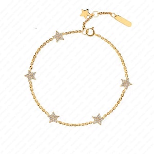 May include: A gold chain bracelet with five star-shaped charms, each set with small clear stones.