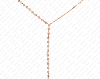 May include: A rose gold necklace with a Y-shaped design and a long, dangling chain of small round diamonds.