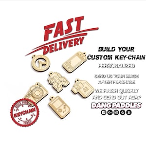 May include: A collection of wooden keychains with various designs, including a camera, a video game console, and a pixelated character. The keychains are displayed on a white background with the text "BUILD YOUR CUSTOM KEY-CHAIN PERSONALIZED SEND US YOUR IMAGE AFTER PURCHASE WE FINISH QUICKLY AND SEND OUT ASAP DANG PADDLES".