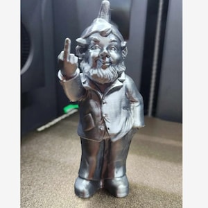 May include: A silver-coloured garden gnome figurine with a pointed hat, wearing a suit jacket and trousers. The gnome is giving the middle finger.