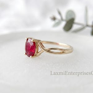Side view of handcrafted sterling silver ruby ring featuring a faceted oval ruby gemstone in a secure prong setting.