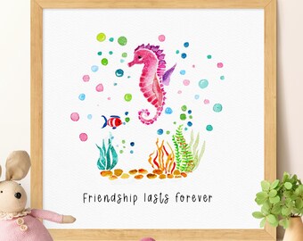 May include: Watercolor print in a wooden frame featuring a pink seahorse, a small red and blue fish, and colorful bubbles. The phrase "Friendship lasts forever" is written below the aquatic scene. The artwork is surrounded by green seaweed and brown pebbles.