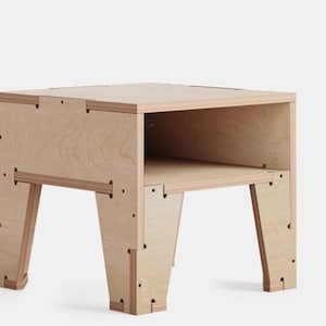 May include: A light wood end table with a shelf and four legs. The table is made of plywood and has a simple, modern design.