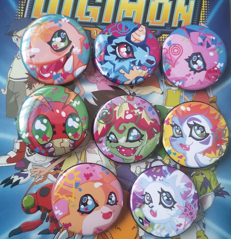 May include: Seven Digimon character button badges with colourful designs. Each badge displays a different character, with vibrant colours and detailed artwork. The round badges have a glossy finish, ideal for fans of the animated series.