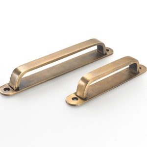 Kitchen drawer handles made from solid brass. Over 80 + styles of cabinet pulls, wardrobe handles, cupboard handles, wall hooks. Cup Pulls.