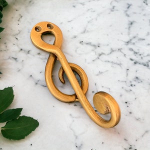 Single brass wall hooks.  Perfect for musicians : bathroom towel hook, coat hooks, coat racks. Guitar hook.  30+ designs, includes screws