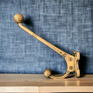 Single brass wall hooks. Aztec design;  bathroom towel hooks, coat hooks, coat racks. Single wall hooks.  30+ designs, includes screws