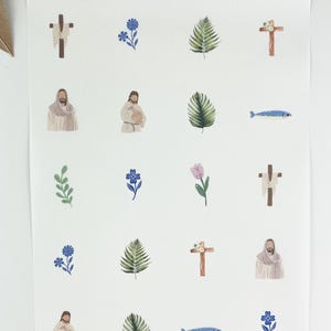May include: A sheet of stickers featuring watercolor illustrations of religious symbols. The stickers include crosses, flowers, palm leaves, a fish, and depictions of Jesus. The color palette is soft, with muted tones of brown, blue, green, and purple.
