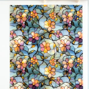 May include: A decorative panel featuring a stained-glass floral design. The pattern includes flowers in shades of orange, pink, and purple, set against a light blue background. Dark lines define the floral shapes and leaves.