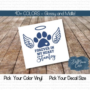 May include: A blue paw print with angel wings and a halo above it. The text "FOREVER IN MY HEART Stanley" is below the paw print. The design is on a white background.