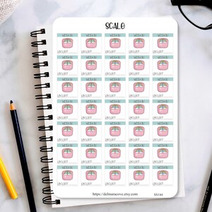 May include: A sheet of 24 weight loss tracker stickers featuring a pink scale with a rainbow design. Each sticker has a space to write in the weight lost and the weight gained. The stickers are perfect for tracking weight loss progress.