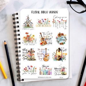 May include: A sheet of floral themed stickers with bible verses. The stickers feature images of flowers, a church, a guitar, a lantern, and a cross. The verses include "God says you are strong", "The Lord is my strength and my song", "She is strong", "Be the light", "Wildflowers grow every morning", "Bless the Lord oh my soul", "You are", "When life gives you thorns, kneel", and "Grow in grace".