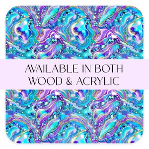 May include: Abstract design with swirling patterns in shades of blue, purple, and gold. The design features a marbled effect with glitter accents. Text on the image reads "AVAILABLE IN BOTH WOOD & ACRYLIC".