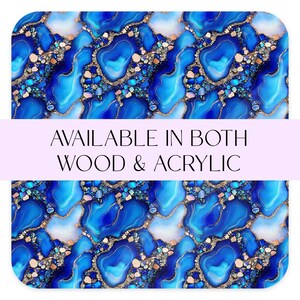 May include: Abstract design with shades of blue, white, and gold. The pattern features a marbled effect with a mix of textures. The text "AVAILABLE IN BOTH WOOD & ACRYLIC" is displayed across the center of the image.