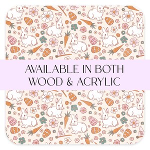 May include: A seamless pattern featuring white bunnies, carrots, and flowers on a cream background. The text "AVAILABLE IN BOTH WOOD & ACRYLIC" is displayed on a purple banner.