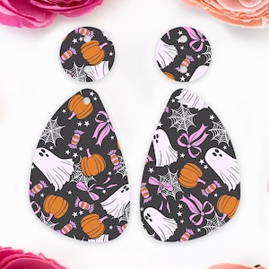 May include: Halloween-themed earrings with a black background, featuring white ghosts, orange pumpkins, pink bows, and candy. The earrings are in a teardrop and circular shape, perfect for a festive look.