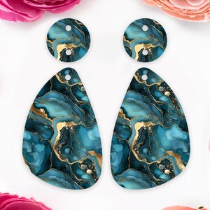May include: A pair of teal blue and gold earrings with a marbleized pattern. The earrings are teardrop shaped and have a smaller round earring with the same pattern.