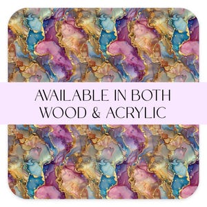 May include: Abstract art print with swirling patterns in shades of pink, blue, and gold. The print features a marbleized effect with gold accents. The text "AVAILABLE IN BOTH WOOD & ACRYLIC" is displayed on a purple banner.