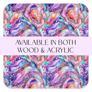 May include: An abstract design with a watercolour-style pattern in shades of purple, orange, blue, and gold. The design resembles a geode with crystal-like details. Text reads "AVAILABLE IN BOTH WOOD & ACRYLIC".