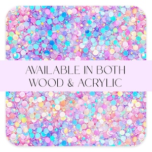 May include: A rectangular design with a colorful, glittery pattern in shades of pink, purple, blue, and yellow. The text "AVAILABLE IN BOTH WOOD & ACRYLIC" is displayed across the center of the image.