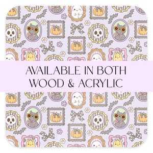 May include: A light purple Halloween-themed pattern featuring framed illustrations of a skull, cat, pumpkin, and ghost. The design includes bats, bows, and flowers. Text reads "AVAILABLE IN BOTH WOOD & ACRYLIC".