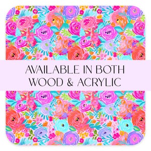 May include: A colorful floral pattern with pink, blue, yellow, and orange flowers on a white background. The text "AVAILABLE IN BOTH WOOD & ACRYLIC" is displayed on a purple banner.