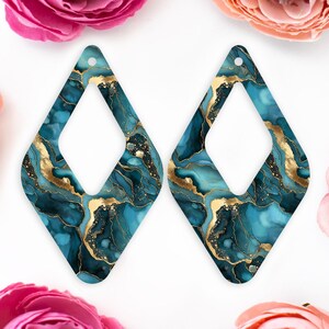May include: A pair of blue and gold diamond-shaped earrings with a marble-like pattern.