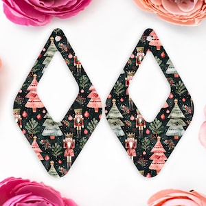 May include: Two diamond-shaped earrings with a Christmas-themed design. The earrings have a dark background adorned with Christmas trees, nutcrackers, and baubles. Each earring has a hole at the top for hanging. The earrings are approximately 7 cm in length.