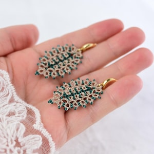 Lace earrings with champagne metallic thread and greenish blue glass beads,