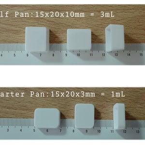 May include: Three white ceramic baking pans of different sizes. The largest pan is labeled "Half Pan: 15x20x10mm = 3mL". The medium pan is unlabeled. The smallest pan is labeled "Quarter Pan: 15x20x3mm = 1mL".