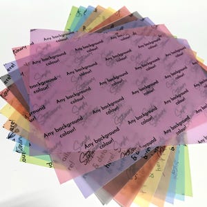 May include: A collection of colorful translucent sheets, fanned out to display a variety of hues. Each sheet has the text "Any background colour!" and "Simply Stationery & details here!" printed on it.