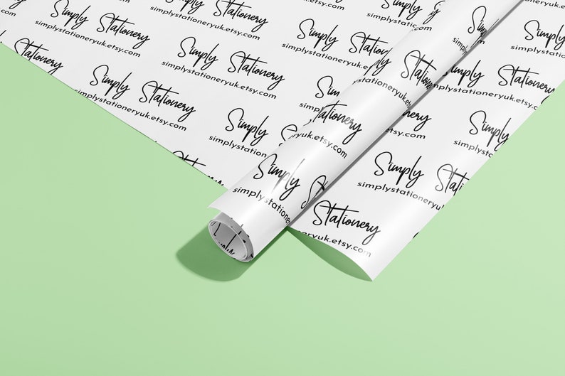 May include: White wrapping paper with a repeating pattern of the text "Simply Stationery" and the website address "simplystationeryuk.etsy.com". The paper is rolled up and partially unrolled, revealing the white background.